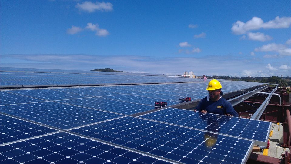 Worker installing solar panels