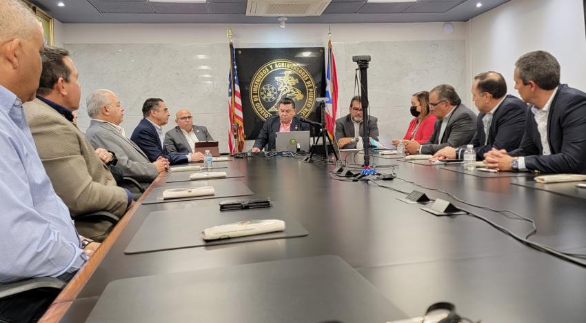 Employees at a long conference table