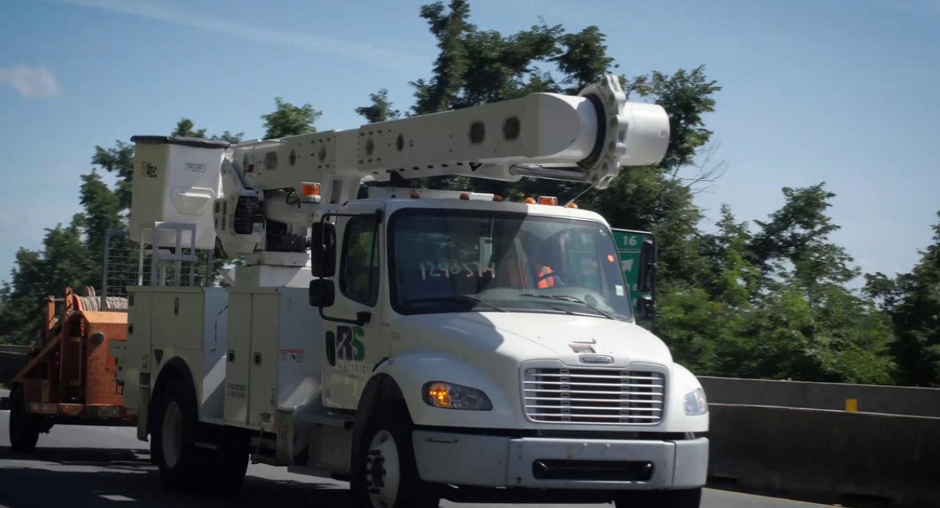 Bucket truck driving on highway