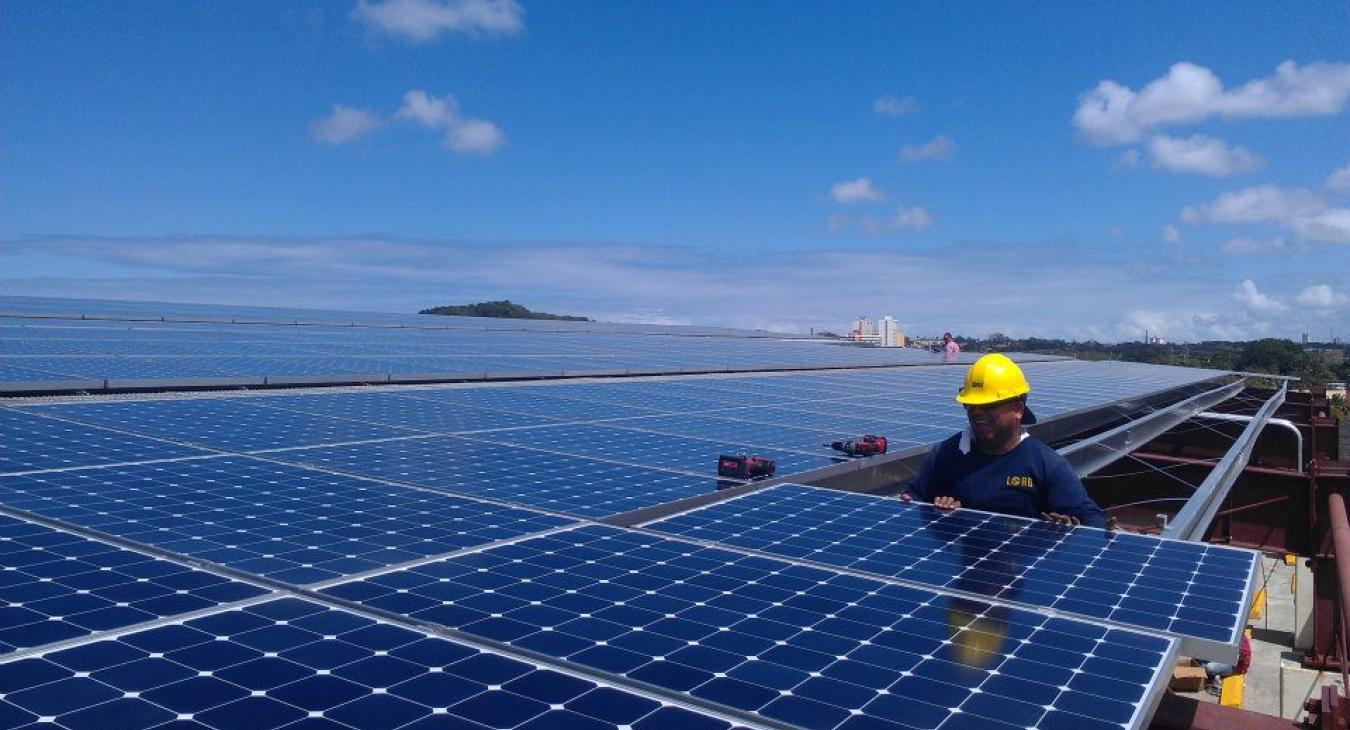 Lord employee installing solar panels