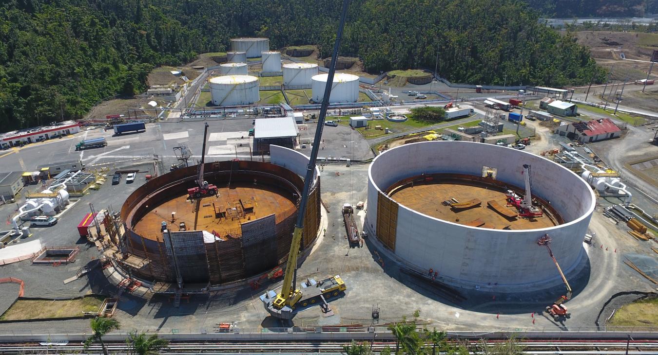 Aerial view of large holding tanks under construction