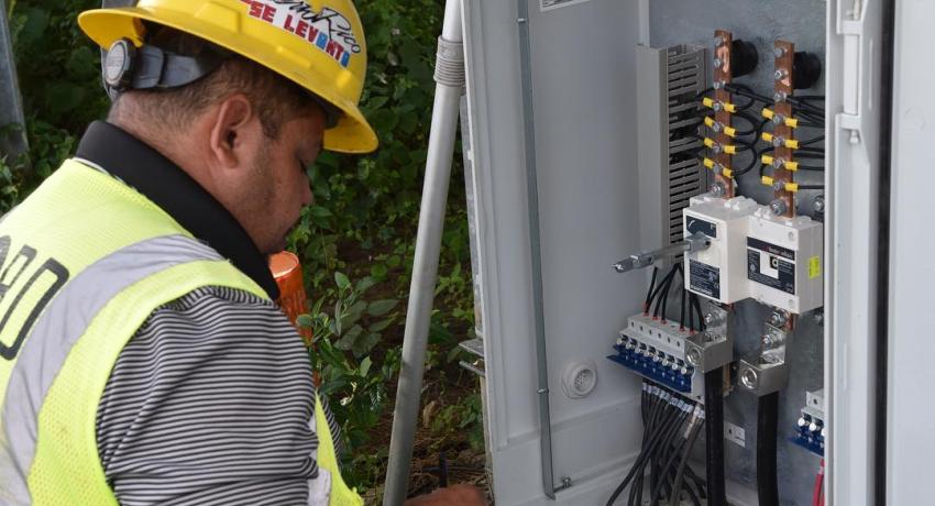 Electrical worker checking electrical panel