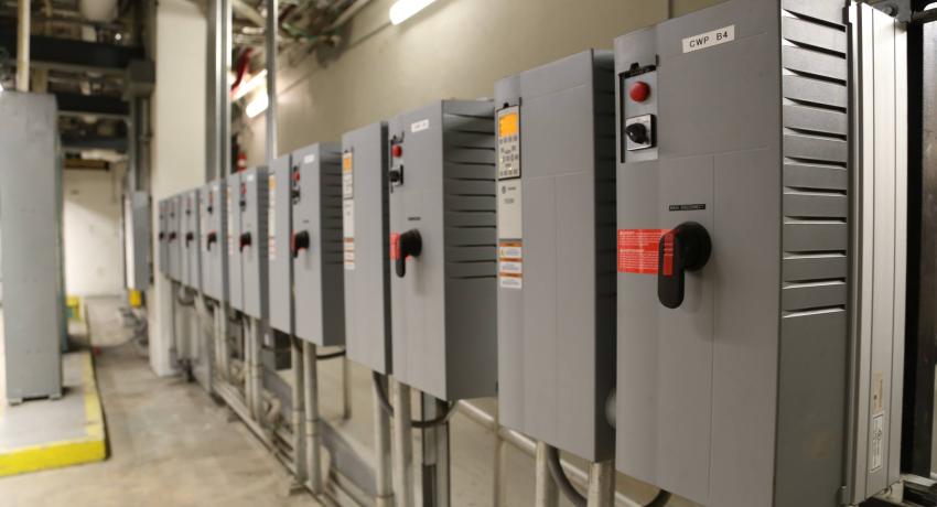 Wall of gray electric panel boxes