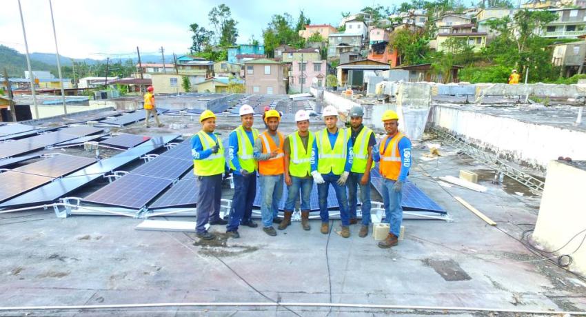 Lord construction workers with rooftop solar panels 