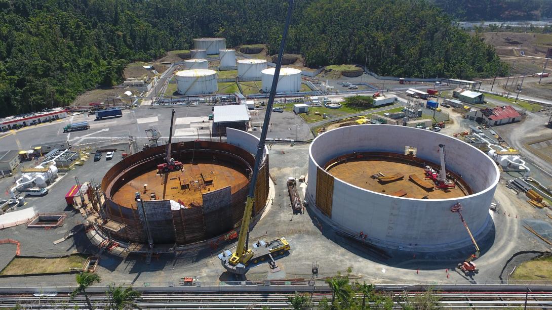 Aerial view of large holding tanks under construction